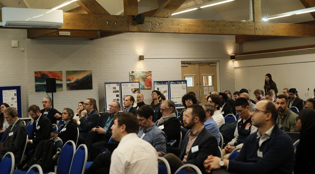 A seated audience watching a presentation